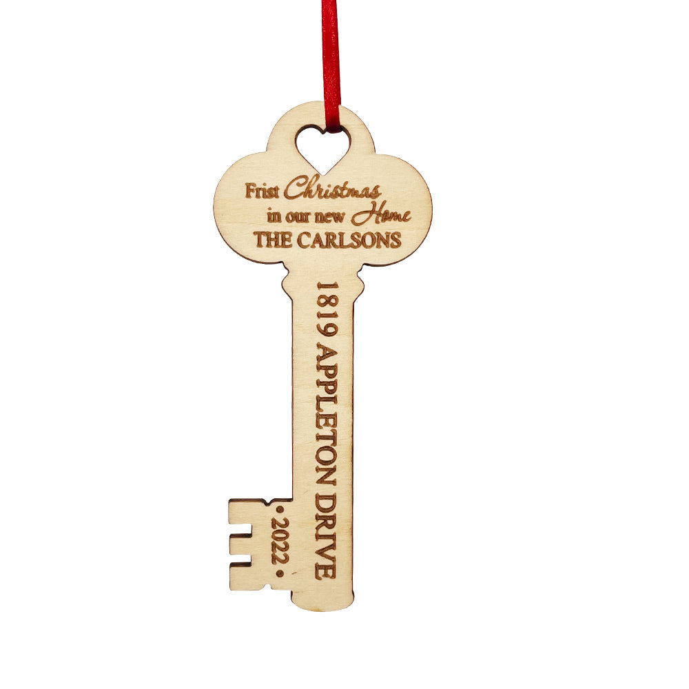 Personalized wooden key ornament, housewarming gift with custom text, red ribbon, new home decor.