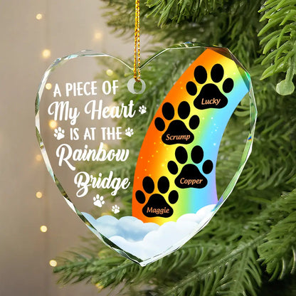 Personalized pet memorial ornament with rainbow and paw prints. Glass heart-shaped Christmas tree decoration.